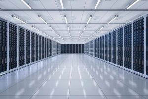 Modern data center with rows of black server racks in a white, sterile environment – illustrating the infrastructure behind IT asset disposition and compliance challenges.