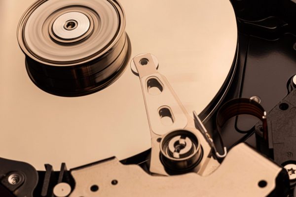 Close-up of an exposed hard disk platter, representing certified data erasure and physical destruction processes for secure IT asset sanitization