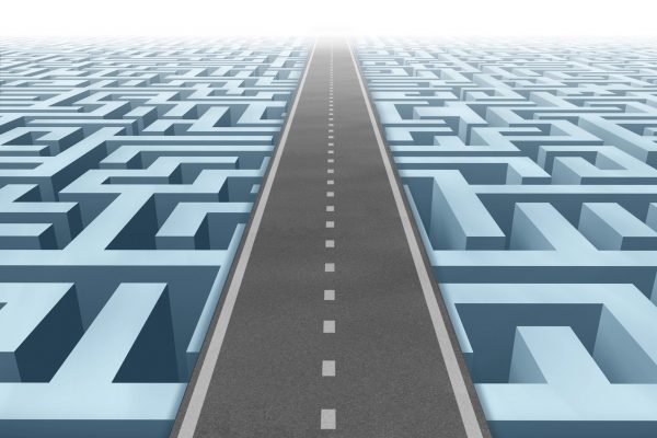 A straight road cutting through a complex maze, symbolizing a clear path through complexity