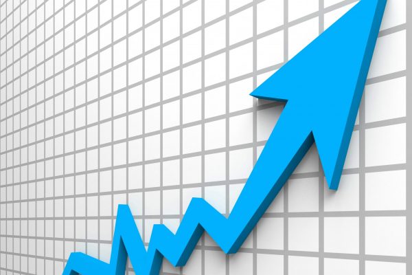 Upward blue arrow graph on grid background representing structured growth and scalable ITAD network development